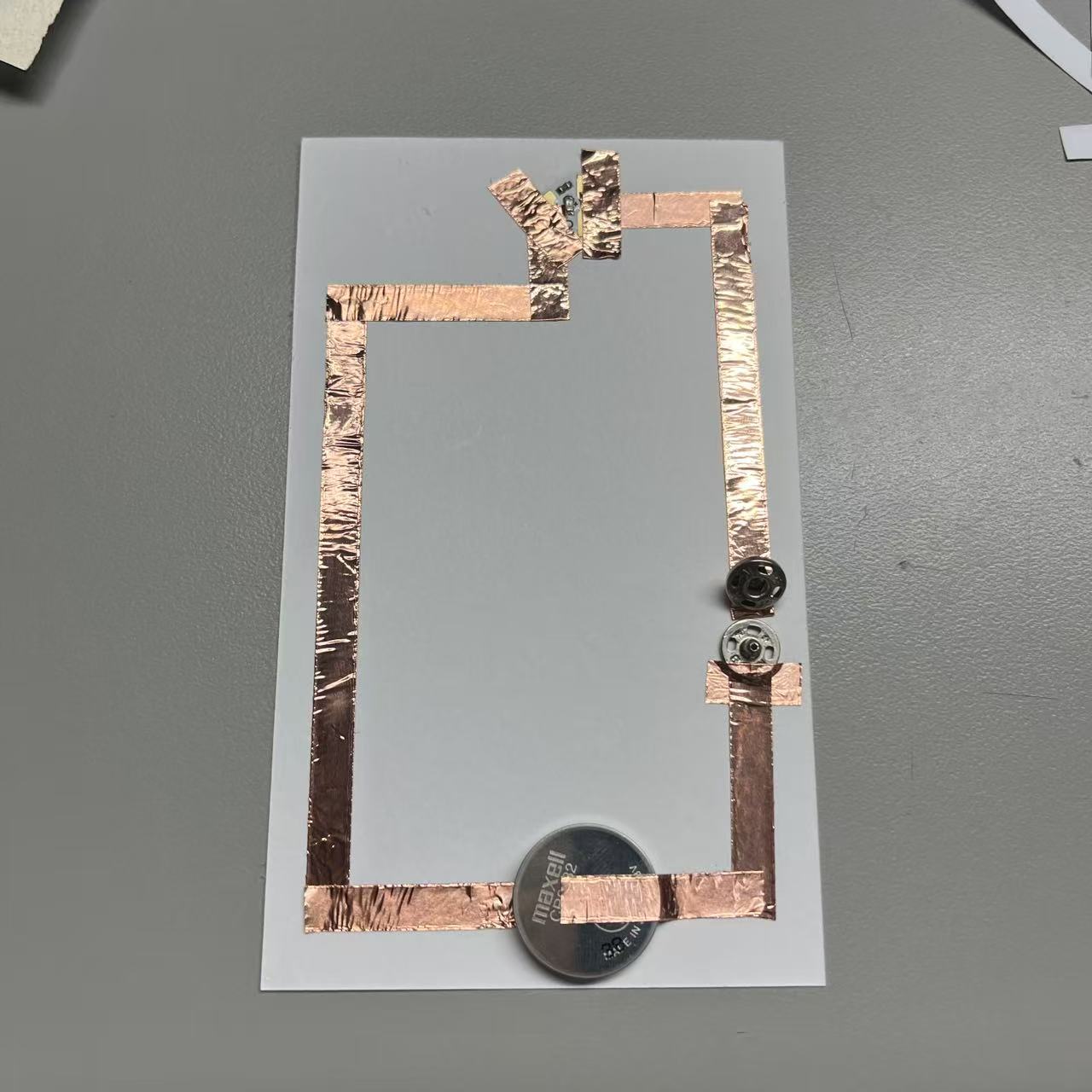 Circuits completed using metal buttons.