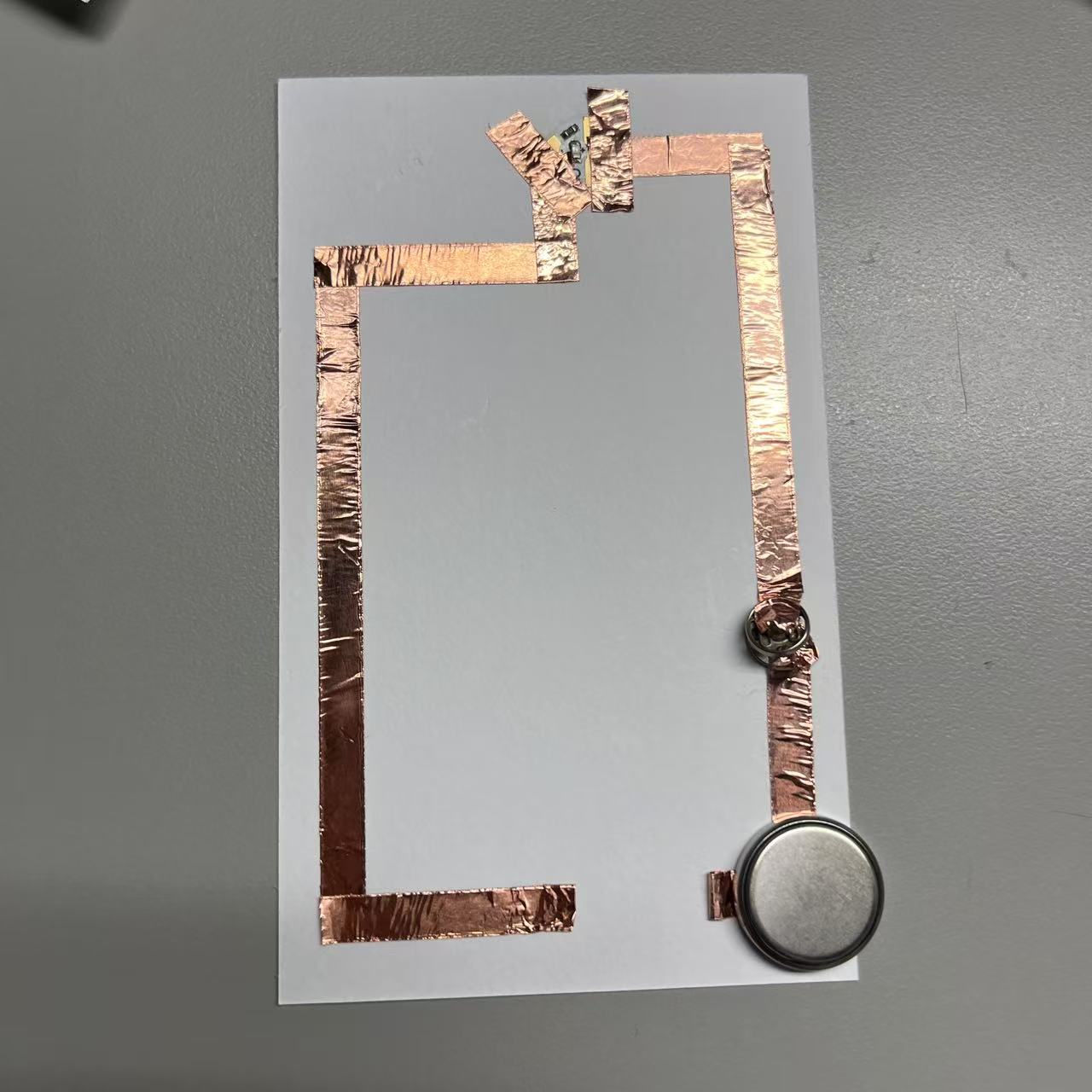 Circuits completed using metal buttons.