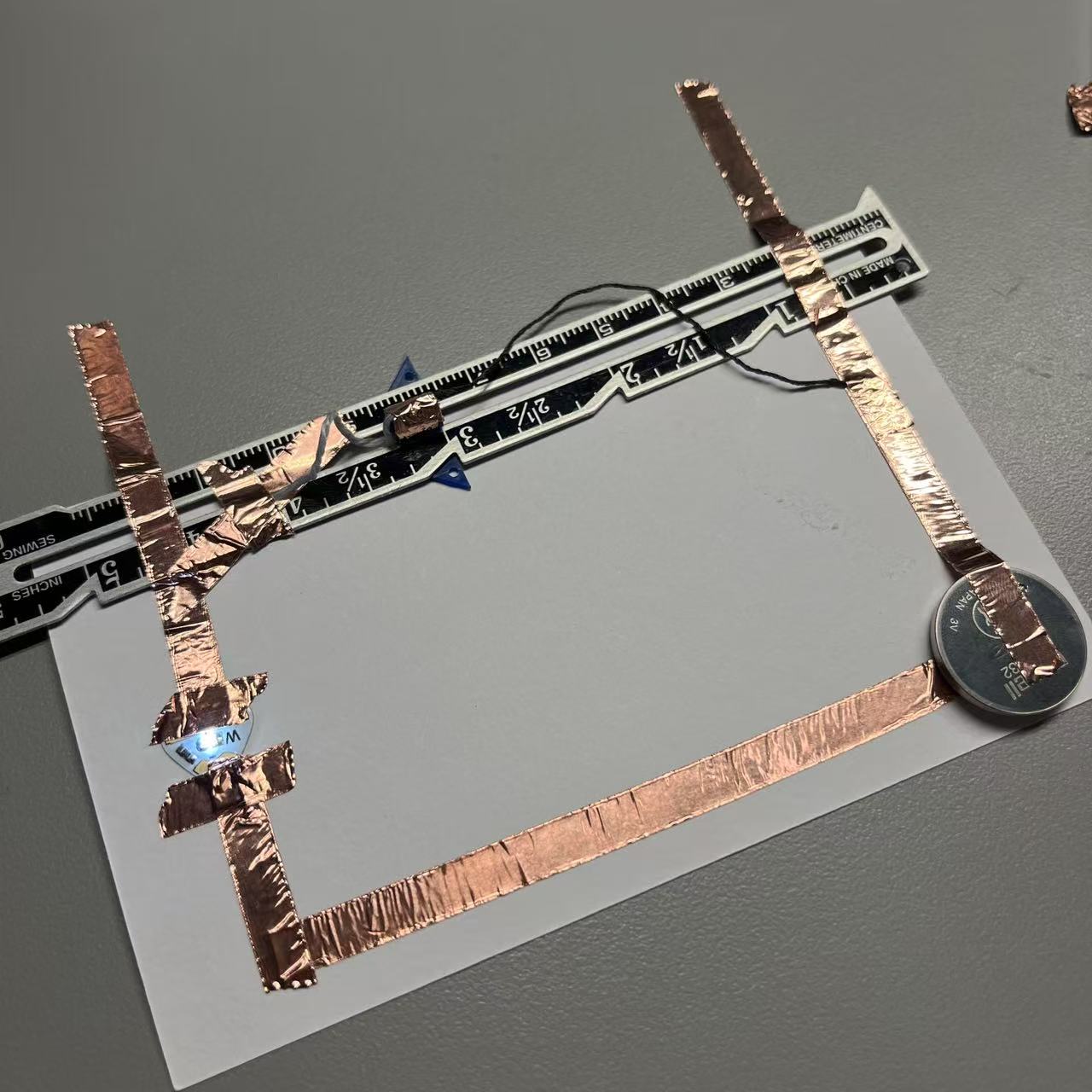 Using wool and a sliding iron ruler, allow the circuit to complete energization.