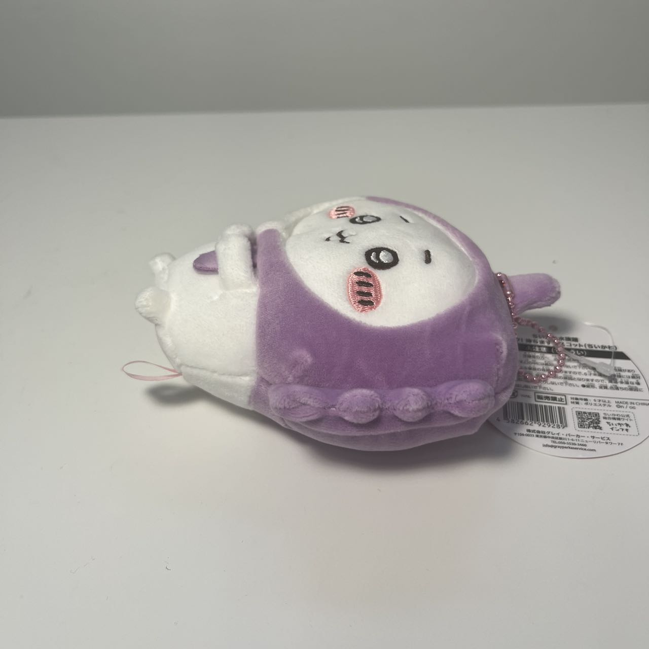 The doll lying on the table.