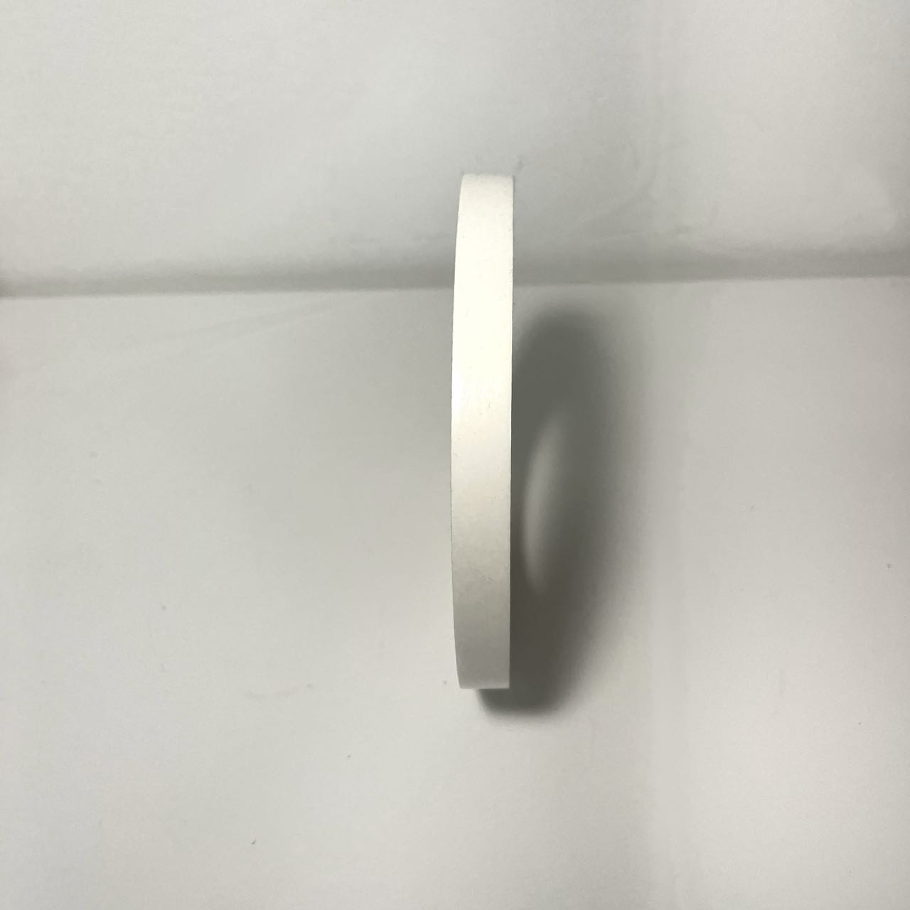 Double-sided tape standing on a table, shot from the side