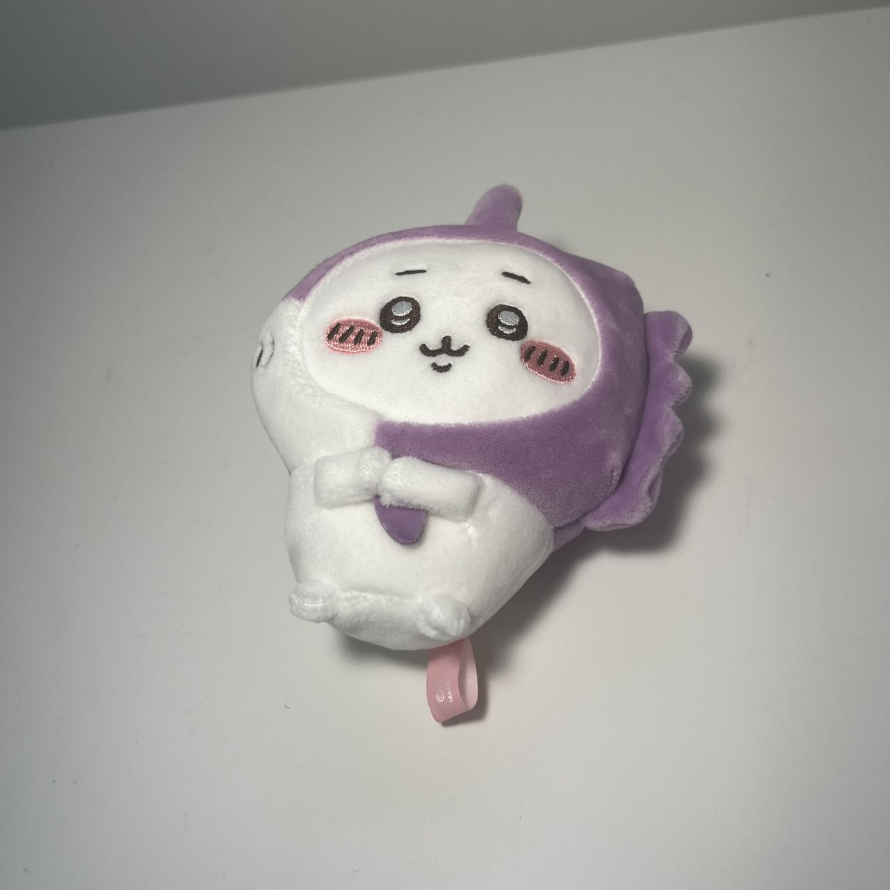 The doll lying on the table.